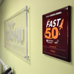 Mohu office- 2014 Triangle Business Journal Fast 50 Award hanging on a light green wall next to a Mohu sign
