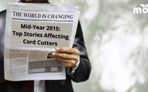 Businessman holding newspaper with the headline Mid-Year 2015: Top Stories Affecting Cord Cutters