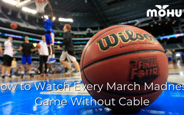 basketball sitting on court with players in the background, How to Watch Every March Madness Game Without Cable, with Mohu logo