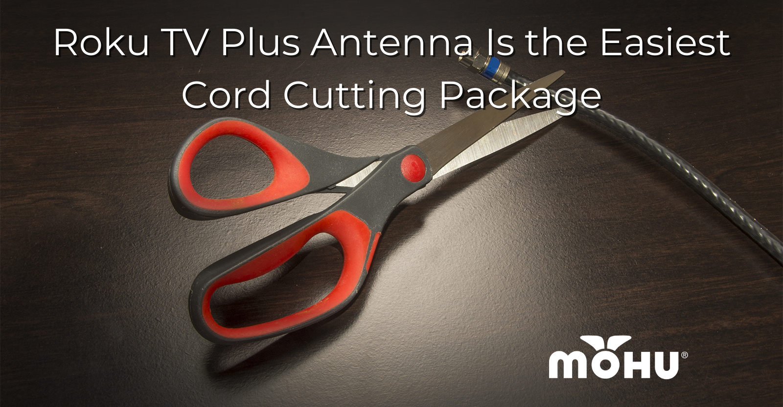 Roku TV Plus Antenna Is the Easiest Cord Cutting Package scissors on a table cutting a coax cable