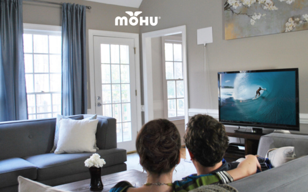 Couple sitting in front of TV with Mohu antenna