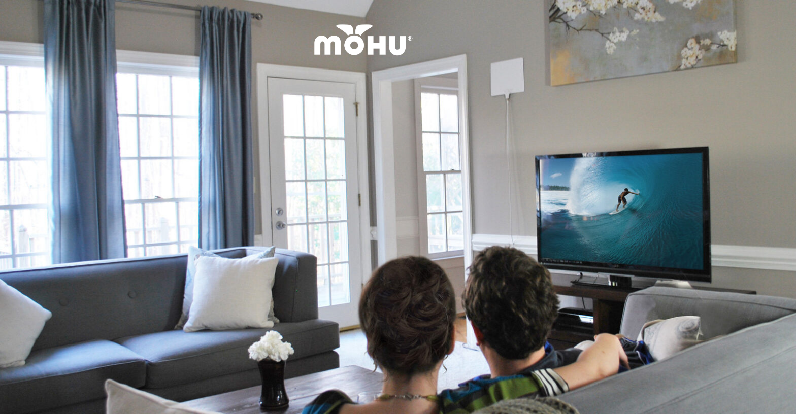 Couple sitting in front of TV with Mohu antenna