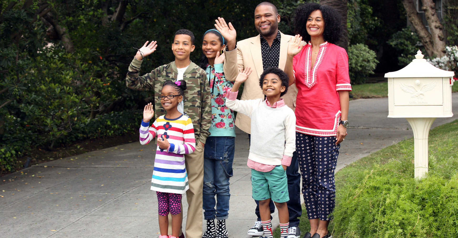 Cast of Black-ish standing outside waving