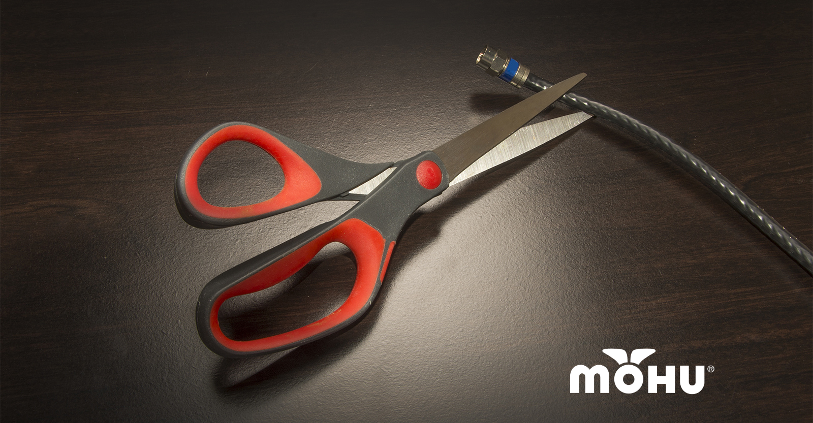 Scissors cutting a coax cable with the Mohu Logo