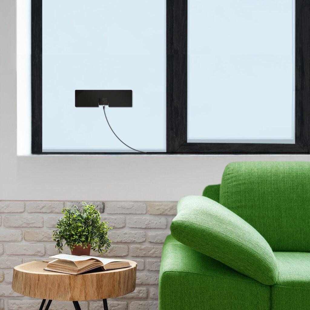 Mohu Leaf Metro TV antenna on window behind couch in living room