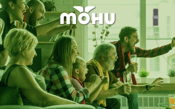 Family watching something exciting on TV with Mohu logo.